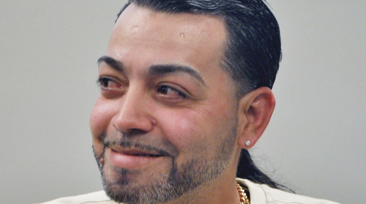 Rafael Rosado, 38, smiles as he talks with one of the counselors at Huther Doyle. Rosado is one of the clients at the facility’s rehabilitation program for Spanish-speaking addicts. He said he’s been clean since December.