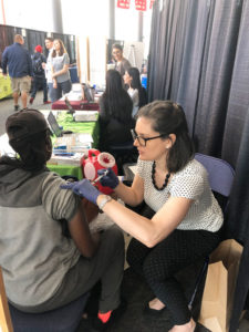 Pharmacist Elizabeth Sutton Burke administering influenza vaccine to one of the attendees during “Day of Services” at Project Homeless Connect.