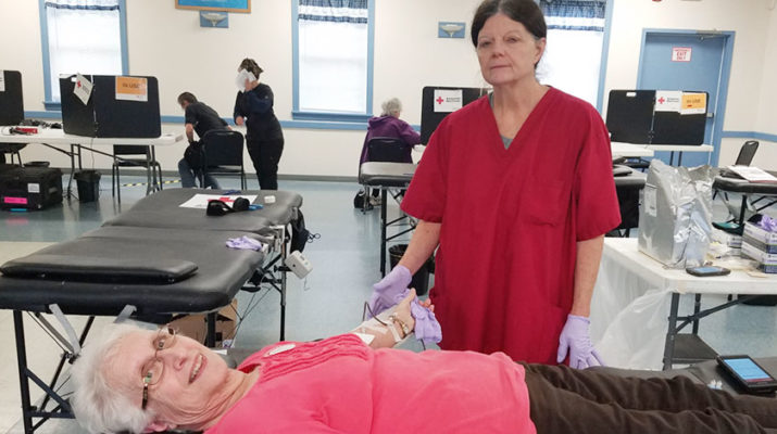 Staff member Colleen Calnan, 62 ,of Irondequoit, helps donor Sandra Phillips, 75, of Clarkson, with her blood donation at a Brockport blood drive. Phillips has been donating blood for over 20 years.