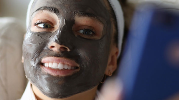 woman with charcoal mask on