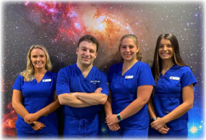 Dr. C with his dental assistants and hygenist at their office in Henrietta.