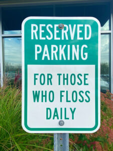 Sign at the parking lot of Celestial Dental on West Henrietta Road urges patients to floss. Photo courtesy of Linda Covington.