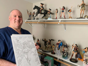 An entire room in Jarrod Atkinson’s Greece home brims with Wonder Woman figures, posters, toys and dolls. He also has a smaller collection at his office at Unity Hospital, where he serves as director of nursing.